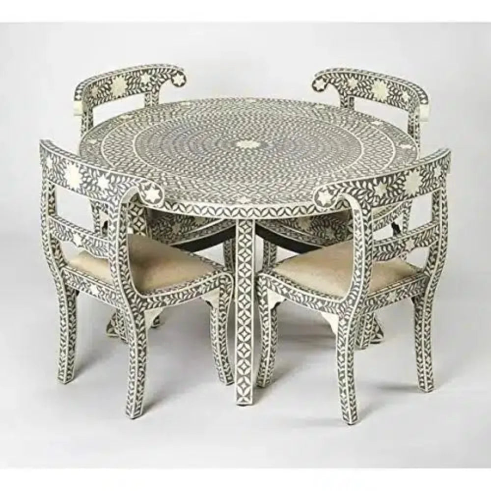 Gray and ivory floral bone inlay round dining table with four matching chairs and cream upholstered seats.