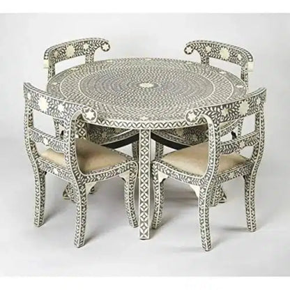 Gray and ivory floral bone inlay round dining table with four matching chairs and cream upholstered seats.