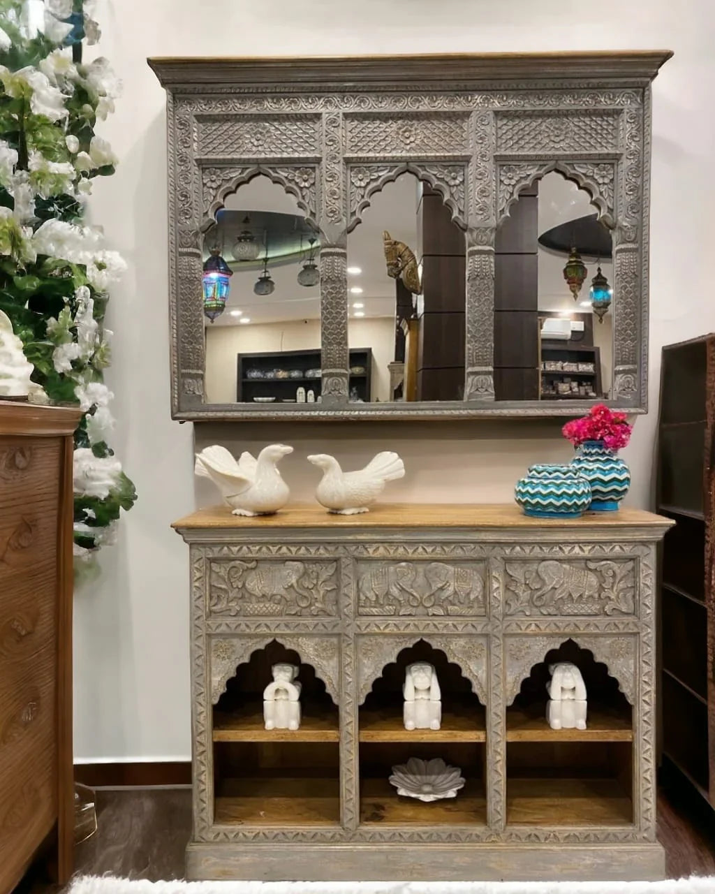  Front room view of a gray triple-arch jharokha wall mirror with carved columns and decorative borders above a console.