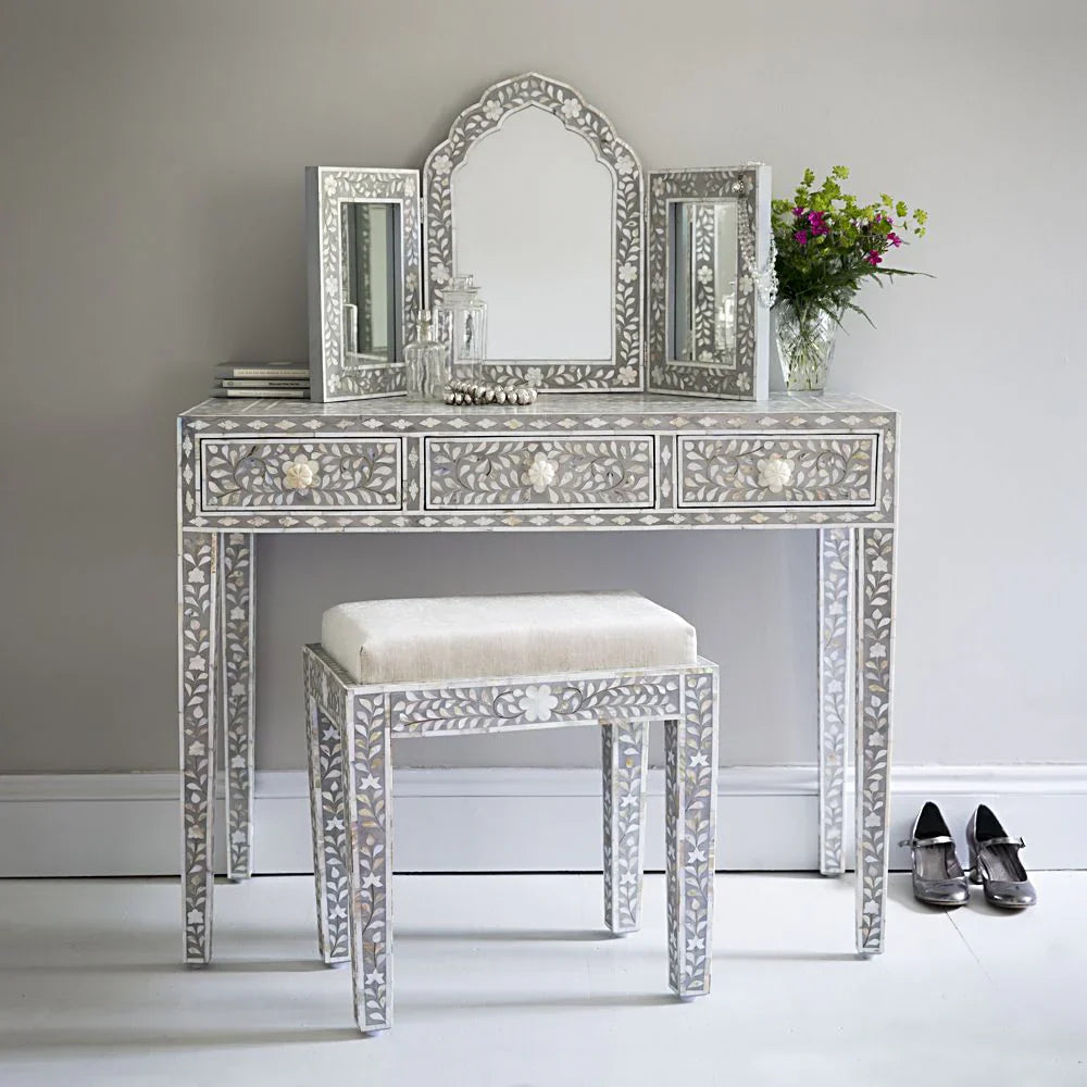 Grey mother-of-pearl floral inlay vanity with three drawers, and a matching cream-cushioned stool.