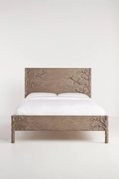 Handcrafted Ornithology platform bed in grey washed mango wood with sculpted branch and leaf relief carvings on headboard and footboard.