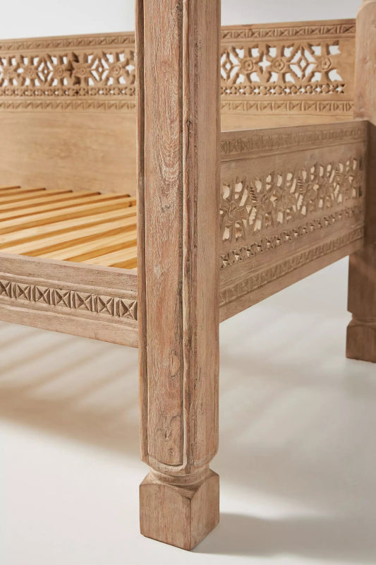 Solid wood canopy daybed featuring hand-carved details, natural finish, and refined global design.