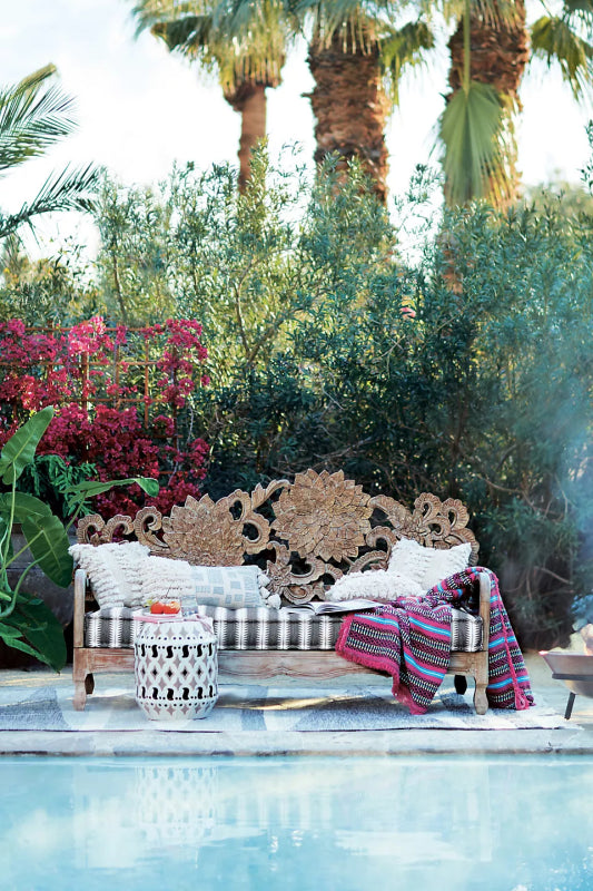 Hand-carved Lotus daybed with a decorative floral backrest and slender armrests.