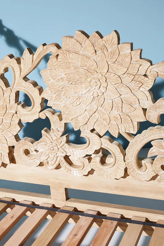 Lotus daybed with a light natural finish and detailed carved woodwork.