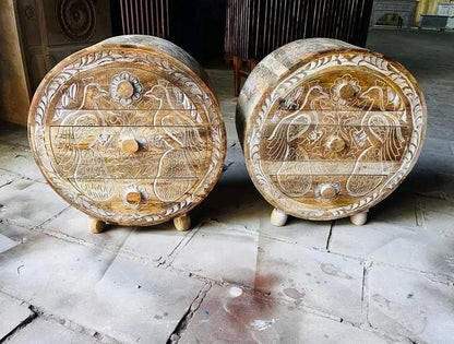 circular solid wood nightstands featuring hand-carved peacock and floral designs in a natural finish with white-washed relief details.