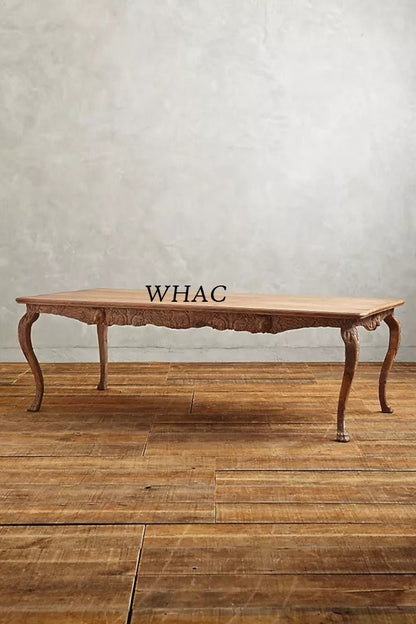 A natural wood version of the hand-carved dining table shown from a side profile, emphasizing the rich grain of the solid wood.