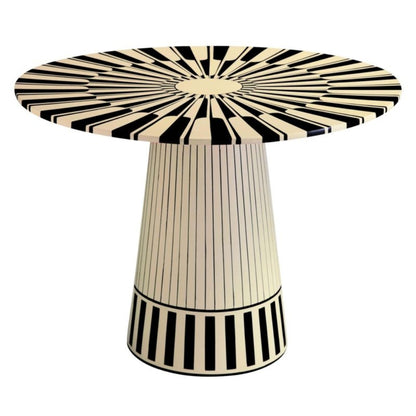 A round pedestal table featuring an intricate black and white bone inlay starburst pattern on the tabletop and vertical pinstripe inlay on the base.