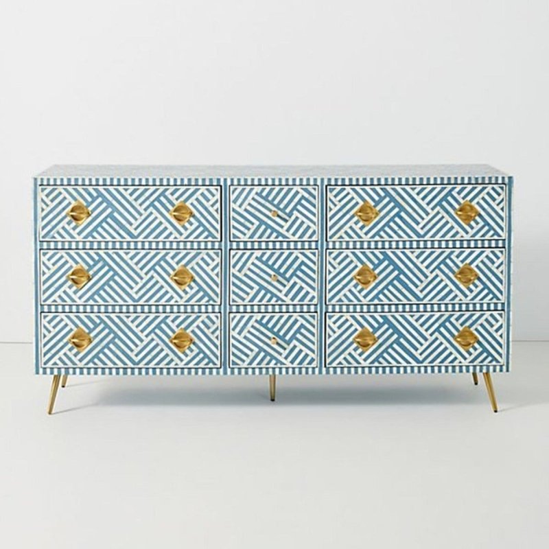 Front view of a large ocean blue and white striped bone inlay 9-drawer dresser with gold geometric knobs and tapered brass legs.