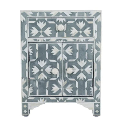Grey and white bone inlay nightstand cabinet with one top drawer, two doors, and a stylized floral geometric pattern.
