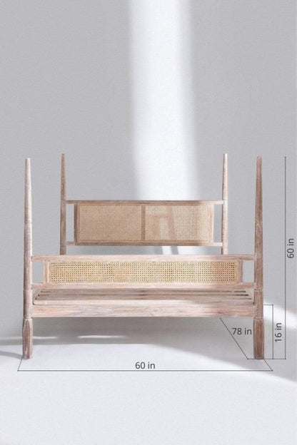 Handmade caned bed with a four-poster canopy frame.