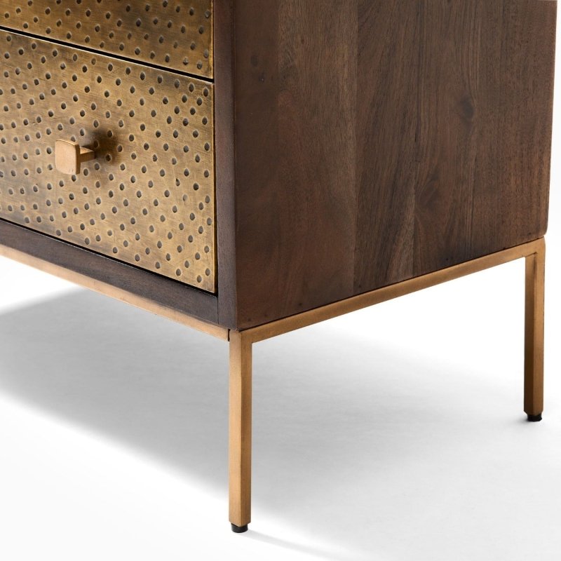 Solid wood chest of drawers finished with textured brass cladding and decorative brass knobs.