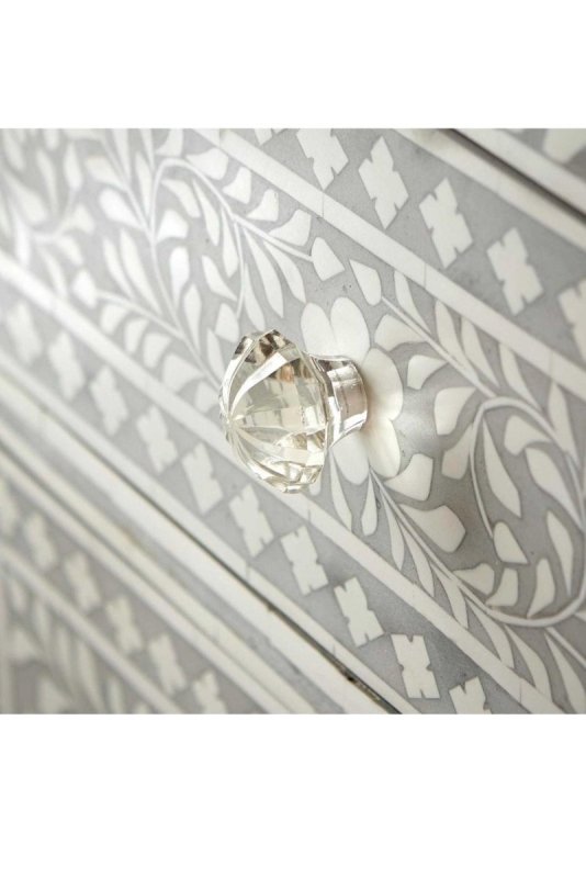 Close-up of grey bone inlay dresser drawer with crystal knob – intricate white floral and leaf inlay pattern detail