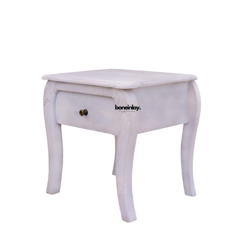 A front-facing view of the Menagerie bedside table, featuring a single storage drawer and an open lower profile. The design is defined by its graceful cabriole legs and a subtle distressed finish, blending boutique charm with functional elegance.
​5. Close-up: Artisanal Carving Detail