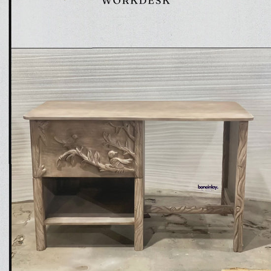 This video showcases a meticulously handcrafted Ornithology Workdesk made from solid wood with a light natural finish. The camera highlights the intricate hand-carved birds and floral branches on the desk's single drawer and side panel, as well as the smooth, spacious tabletop and open lower storage shelf. Final frames detail the high-quality wood grain and seamless drawer operation, ending with promotional text for worldwide delivery and customization.