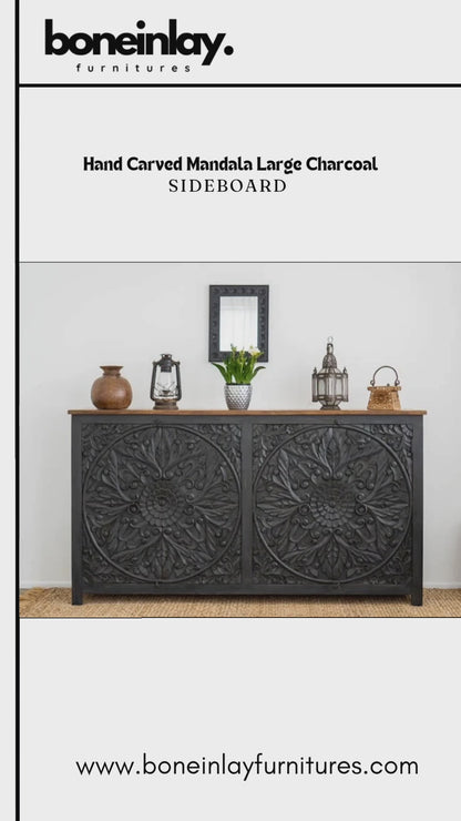 Black wooden mandala credenza video preview showing a front view of the carved floral doors, circular ring pulls and natural wood top, styled with decorative lanterns and pottery beneath a framed portrait.