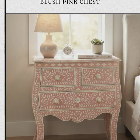 A French-style blush pink chest features intricate handmade bone inlay leaf and floral motifs across its top surface, front drawers, and elegant curved cabriole legs. The chest includes two small top drawers and two full-width bottom drawers adorned with matching inlay knobs