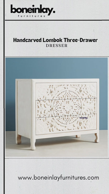 The dresser features a clean, white-washed finish with a large, intricate hand-carved mandala design extending across the front of all three drawers.
A hand is shown opening the middle drawer to reveal the natural grain of the solid wood interior and smooth sliding mechanism.