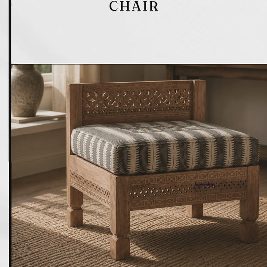 This Hand Carved Ezana Armless Chair Features A Beautifully Detailed Wooden Frame With A Lattice Design On The Backrest And Base. It Includes A Comfortable, Thick Striped Cushion That Perfectly Complements The Light Natural Wood Finish. The Sturdy Square Legs And Intricate Carvings Make It A Perfect Accent Seating Option For A Cozy Corner. Designed By Bone Inlay Furnitures, It Seamlessly Combines Bohemian Elegance With Practical Comfort.