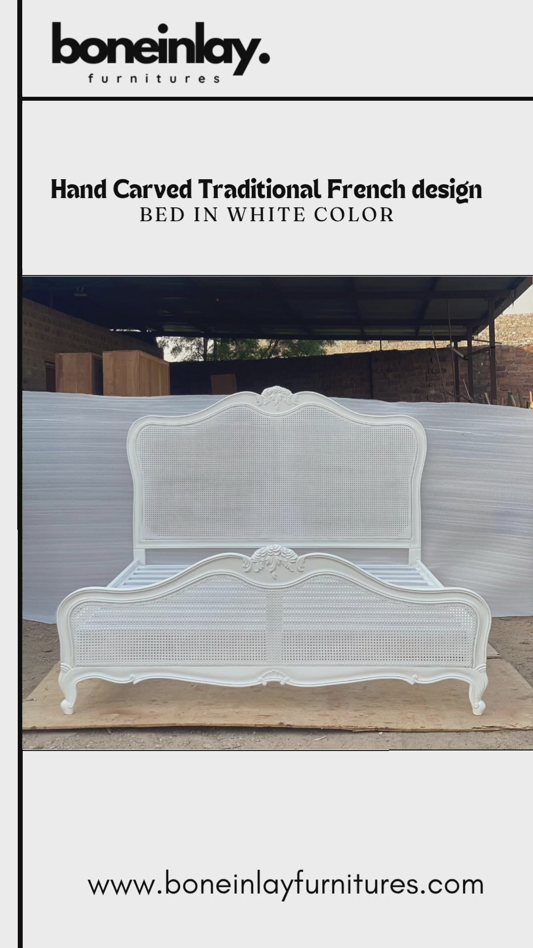A factory video showcasing a handcrafted, solid wood French Provincial bed in a matte white finish. It features an arched headboard with natural caned panels and intricate, hand-carved floral motifs along the crest and cabriole legs. The video highlights the sturdy slatted support system and offers free worldwide delivery with customization options.