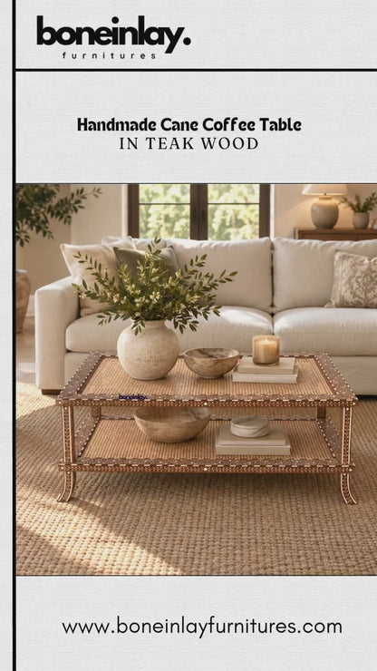 The video presents a handmade cane coffee table crafted in teak wood from Bone Inlay Furnitures. The rectangular two-tier table features woven cane panels on both shelves framed by intricate decorative inlay borders and curved legs. It is initially staged in a warm, cozy living room before being displayed on its own against a neutral background.