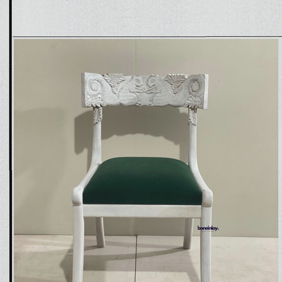 Artisan video showcasing the 'Fable' collection of hand-carved solid wood dining chairs, featuring intricate floral backrests, traditional chiseled patterns, and premium upholstered seating in a boutique workshop setting.