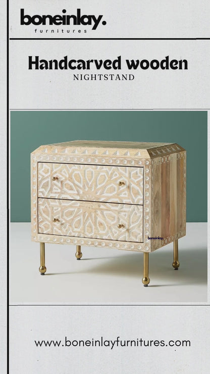 Handcrafted wooden nightstand with white bone inlay featuring a central starburst mandala and geometric borders. Includes two drawers with brass knobs and slender gold-finished legs. Video demonstrates smooth drawer opening and detailed artisanal construction