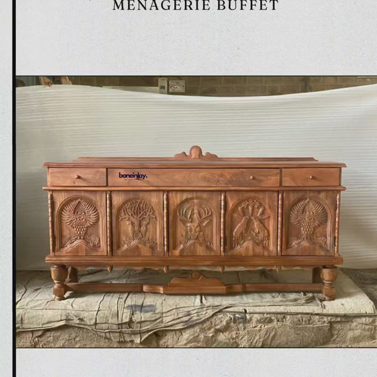 This video highlights a handcrafted wooden buffet with a natural honey-brown finish, featuring five arched door panels meticulously hand-carved with a menagerie of wildlife motifs, including an owl, a stag, and a majestic tree. The buffet is designed with three top drawers and spacious internal shelving, blending rustic craftsmanship with practical storage. Set in an artisanal workshop, the video showcases the rich wood grain and intricate details, positioning this piece as a sophisticated focal point for a