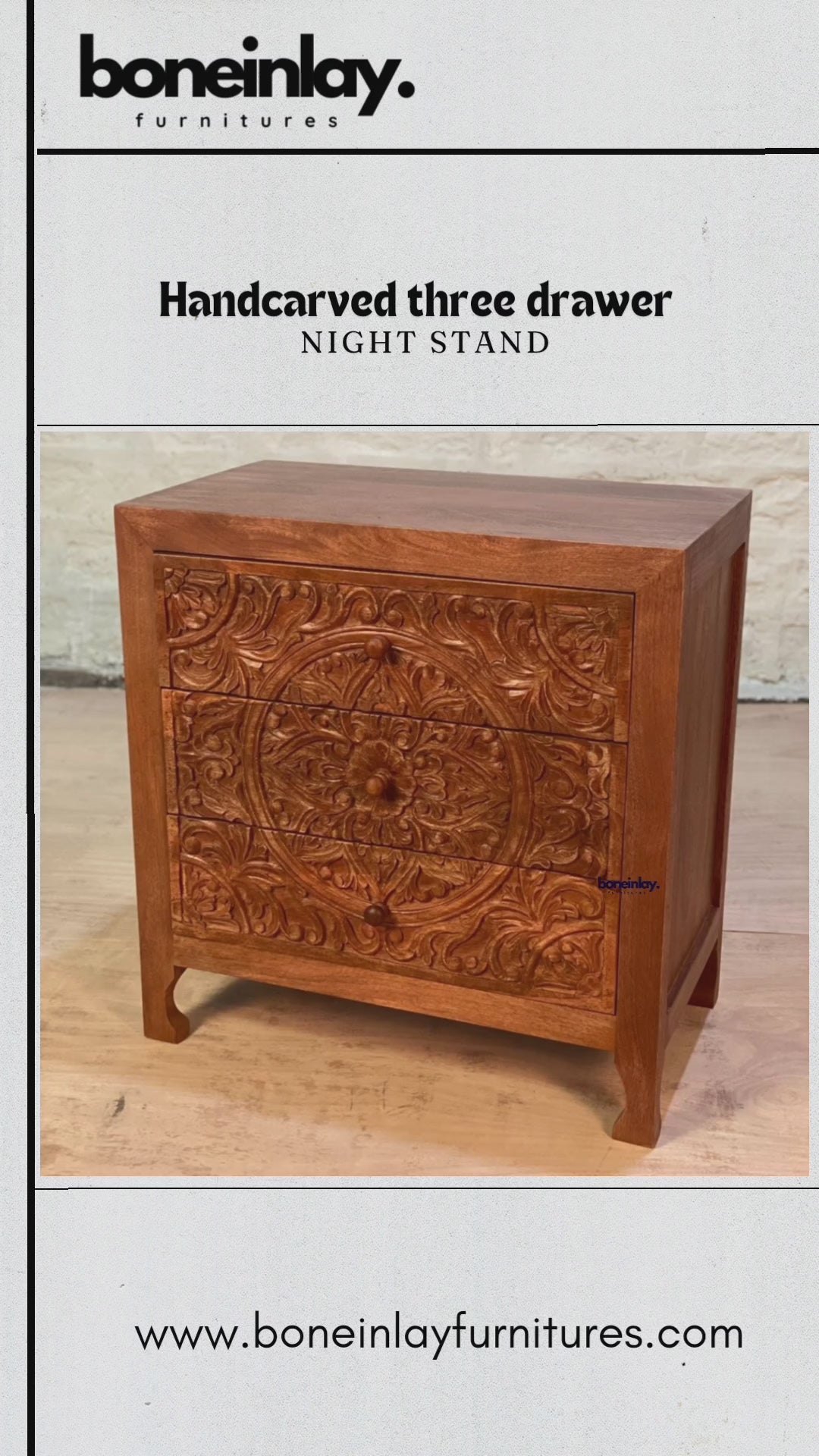 A compact, three-drawer wooden nightstand featuring a rich, warm finish and an intricate, hand-carved floral mandala across the drawer fronts. The piece combines a rustic farmhouse feel with elegant, tapered legs and matching round wooden knobs.