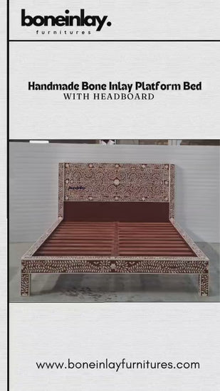 The "Handmade Bone Inlay Platform Bed" is a stunning statement piece, featuring a rich, dark-toned backdrop accented by an intricate, hand-carved white floral vine pattern that runs across the entire headboard and footboard frame. The design seamlessly blends traditional artistry with a clean, contemporary silhouette, creating a luxurious and sophisticated aesthetic. Its sturdy platform construction offers a perfect balance of durability and elegant design, making it a beautiful focal point for any bedroom.