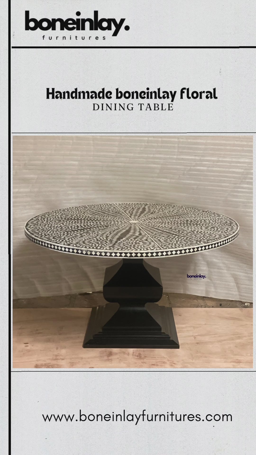 A round, handmade bone inlay dining table featuring an intricate black and white floral and leafy pattern that radiates outwards from the center. The ornate, circular tabletop sits atop a sturdy, geometric pedestal base finished in solid matte black. The rim of the tabletop is detailed with a contrasting black and white checkerboard border.