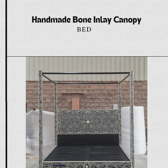 This "Handmade Bone Inlay Canopy Bed" features a striking black frame meticulously covered in an intricate white leaf and vine bone inlay pattern. The bed combines a detailed, matching inlaid headboard panel with a grand, structured four-poster silhouette, creating a dramatic and elegant focal point for a master bedroom. The video displays the bed from multiple angles, highlighting the rich contrast and exceptional artisanal craftsmanship of the design.