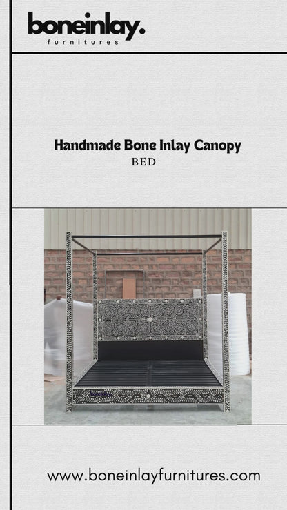 This "Handmade Bone Inlay Canopy Bed" features a striking black frame meticulously covered in an intricate white leaf and vine bone inlay pattern. The bed combines a detailed, matching inlaid headboard panel with a grand, structured four-poster silhouette, creating a dramatic and elegant focal point for a master bedroom. The video displays the bed from multiple angles, highlighting the rich contrast and exceptional artisanal craftsmanship of the design.