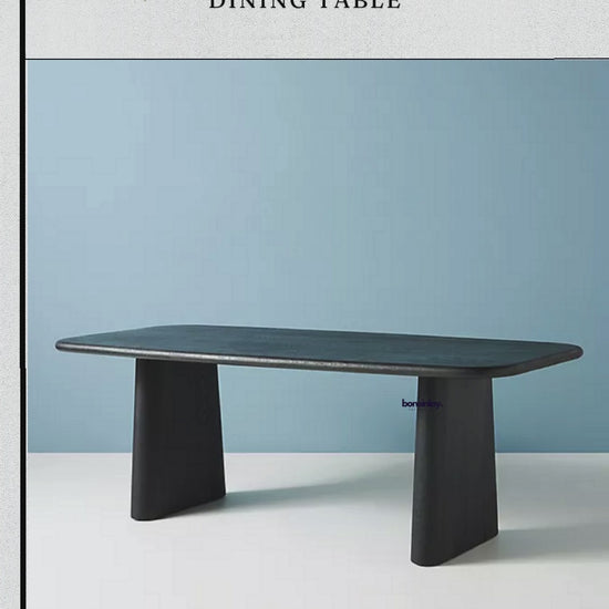 A promotional video showcase for the "Kalle Sculptural Dining Table" by Boneinlay Furnitures.
It features close-ups highlighting the table's dark wooden finish, smooth rounded edges, and wide pedestal base.
The video displays multiple viewing angles, modern dining room staging,