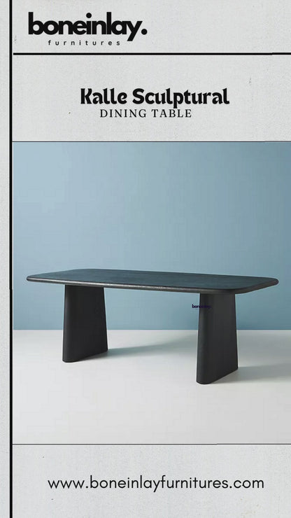 A promotional video showcase for the "Kalle Sculptural Dining Table" by Boneinlay Furnitures.
It features close-ups highlighting the table's dark wooden finish, smooth rounded edges, and wide pedestal base.
The video displays multiple viewing angles, modern dining room staging,