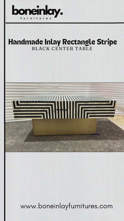 The Handmade Inlay Rectangle Stripe Black Center Table is a striking piece of furniture featuring a bold, monochromatic geometric stripe pattern on its surface. It stands on a sturdy metallic base with a gold finish, perfectly blending modern style with artisanal craftsmanship. You can shop this table and explore more unique items at www.boneinlayfurnitures.com, where they offer free worldwide delivery, customization, and secure payment options.