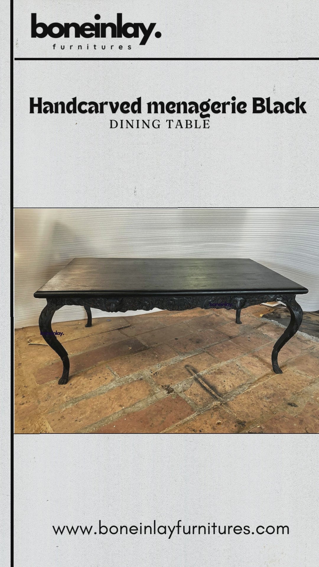 A large rectangular black dining table with a detailed hand-carved apron featuring a lion's head and forest animals. The table has four curved cabriole legs with ornate leaf carvings and ball-and-claw feet, all in a matte black finish.