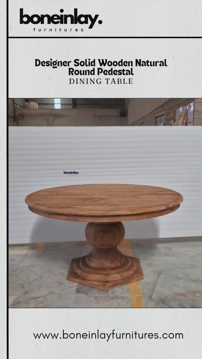 A factory video for a solid wood pedestal dining table with a natural honey finish. The video features a large, round tabletop supported by a single, chunky baluster-style pedestal base with an octagonal platform. It highlights the piece’s traditional silhouette and warm wood grain, advertising free worldwide delivery, custom options, and bulk discounts.