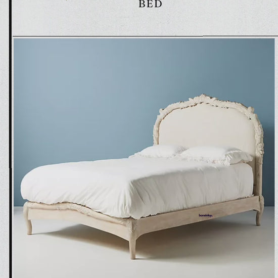 Detailed 360-degree video of a handcrafted Anthropologie Menagerie bed frame. Features distressed white-wash solid wood, intricate hand-carvings, and a pinstriped linen headboard. 
