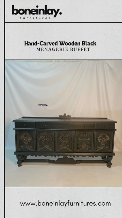 This artisan hand-carved solid wood sideboard is finished in a sophisticated matte black, featuring five arched door panels meticulously detailed with a wildlife menagerie motif. The carvings showcase intricate designs including an owl with outspread wings, a stag, and a central tree of life, all anchored by ornate turned legs and a decorative lower stretcher. This statement storage piece blends gothic elegance with traditional craftsmanship, making it a dramatic focal point for a dining room or entryway.