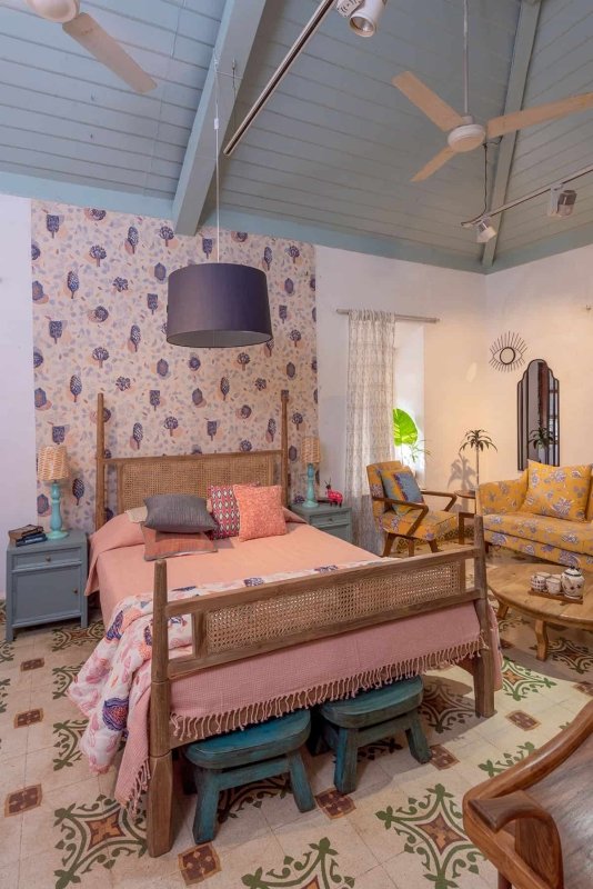 Wooden four-poster bed with cane panels and a rustic-style frame.