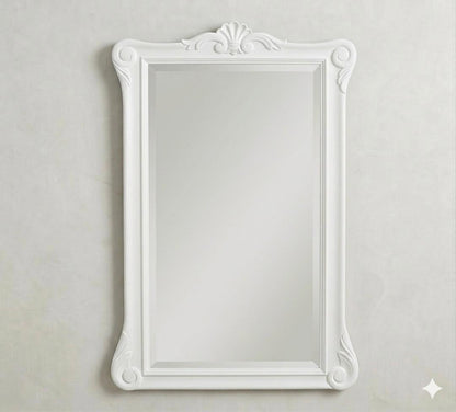 The same ornate Menara wall mirror shown in a pristine white finish, offering a softer, romantic take on the "Enchantment" design theme.