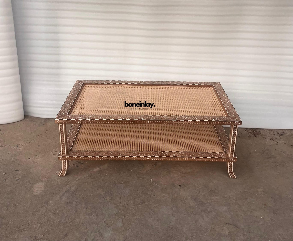 Full view of a rectangular wood inlay coffee table featuring floral-patterned borders and two woven cane surfaces.