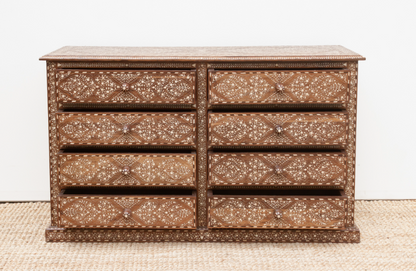 Front view of a floral wood inlay dresser with eight drawers partially open and round decorative knobs.