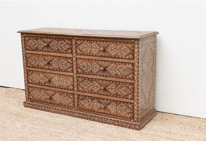 Angled view of an eight-drawer wood inlay dresser showing intricate floral patterns across the front, top, and side panel.