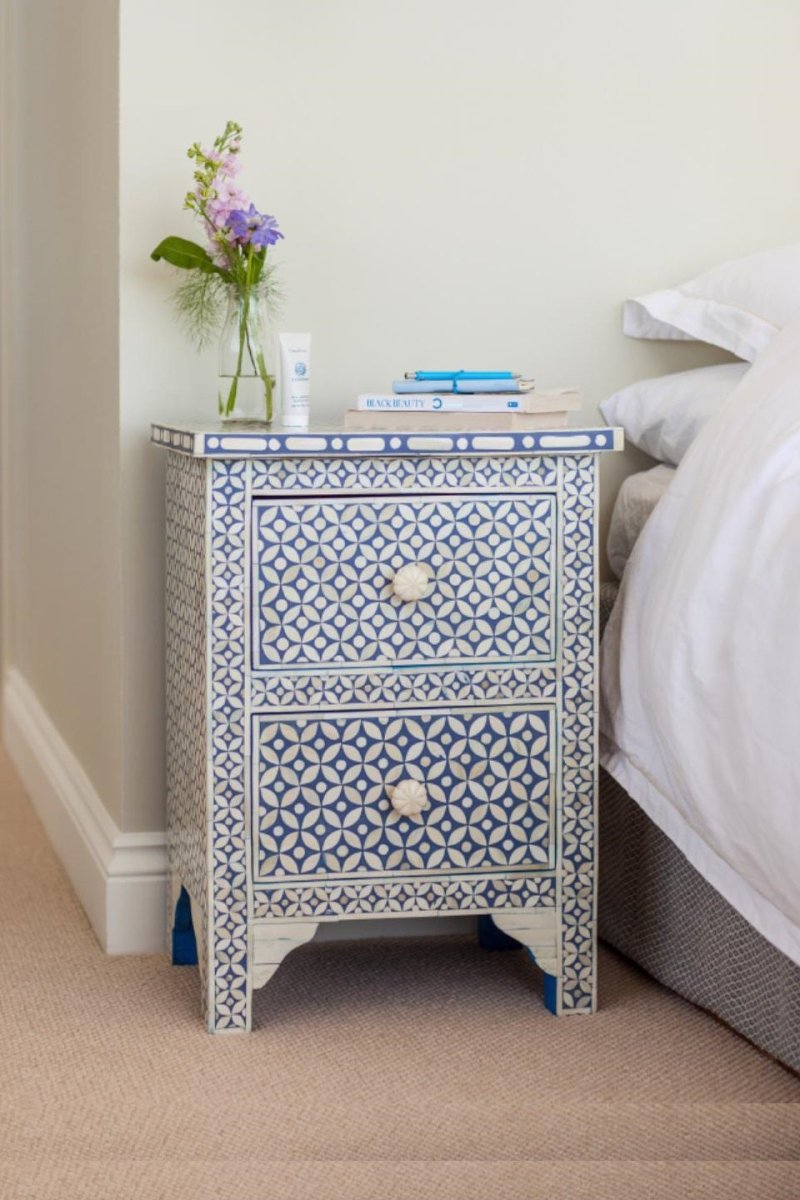 Blue bone inlay nightstand table featuring a repeating star and circle pattern across the front, two storage drawers, floral knobs, and a decorative lower base.