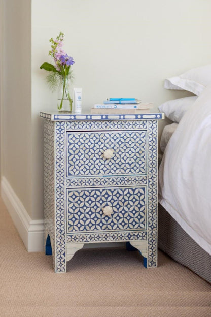 Blue bone inlay nightstand table featuring a repeating star and circle pattern across the front, two storage drawers, floral knobs, and a decorative lower base.