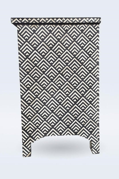 Black and ivory bone inlay chest of drawers shown in side profile, highlighting the stepped base and slim cabinet depth.