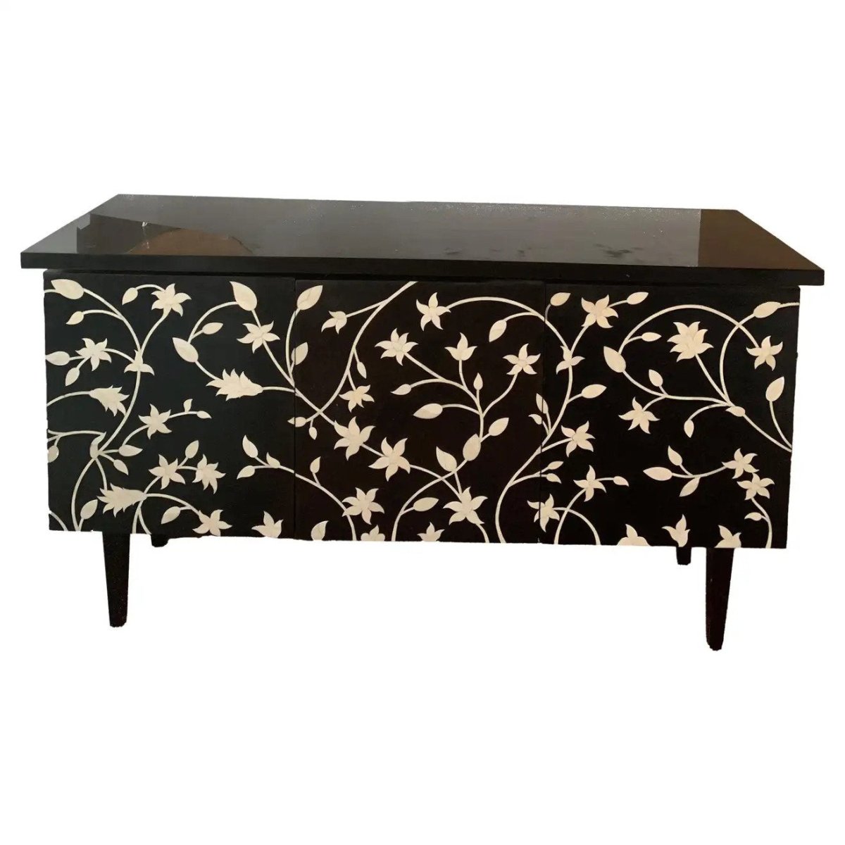 Black bone inlay credenza with hand-carved ivory floral vine pattern across three-door front, solid mango wood construction on tapered legs