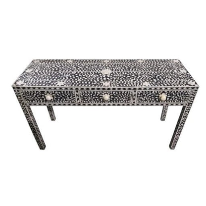 Elevated view of a black bone inlay console table with all-over floral inlay on drawers and legs, bone flower knobs, handmade on mango wood frame, white background.