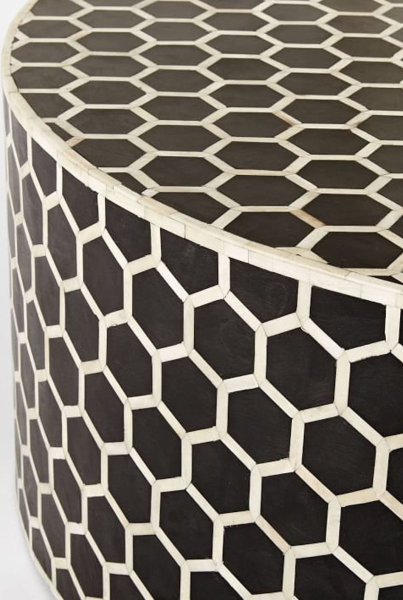Close-up view of the black bone inlay honeycomb pattern on a handmade round coffee table, showing the geometric hexagon detailing across the surface.